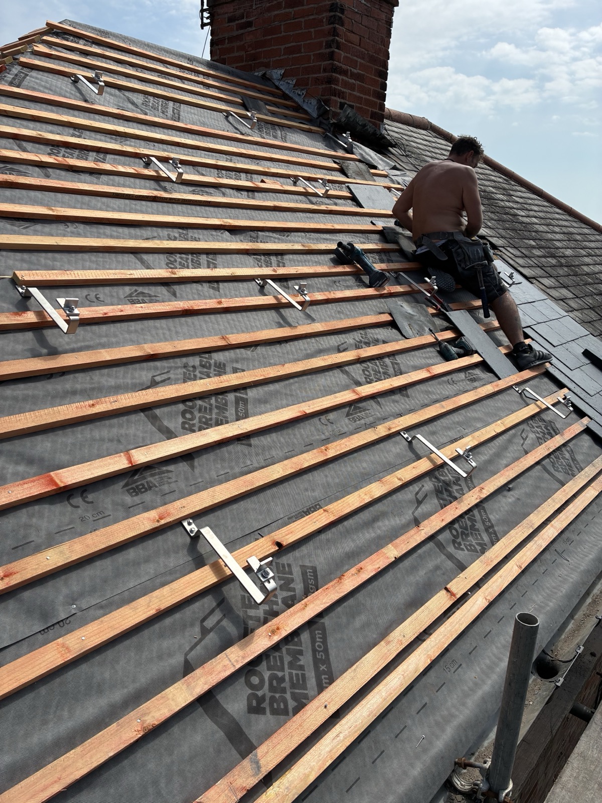 Clenergy solar mounting rails fitted during a new slate roof installation